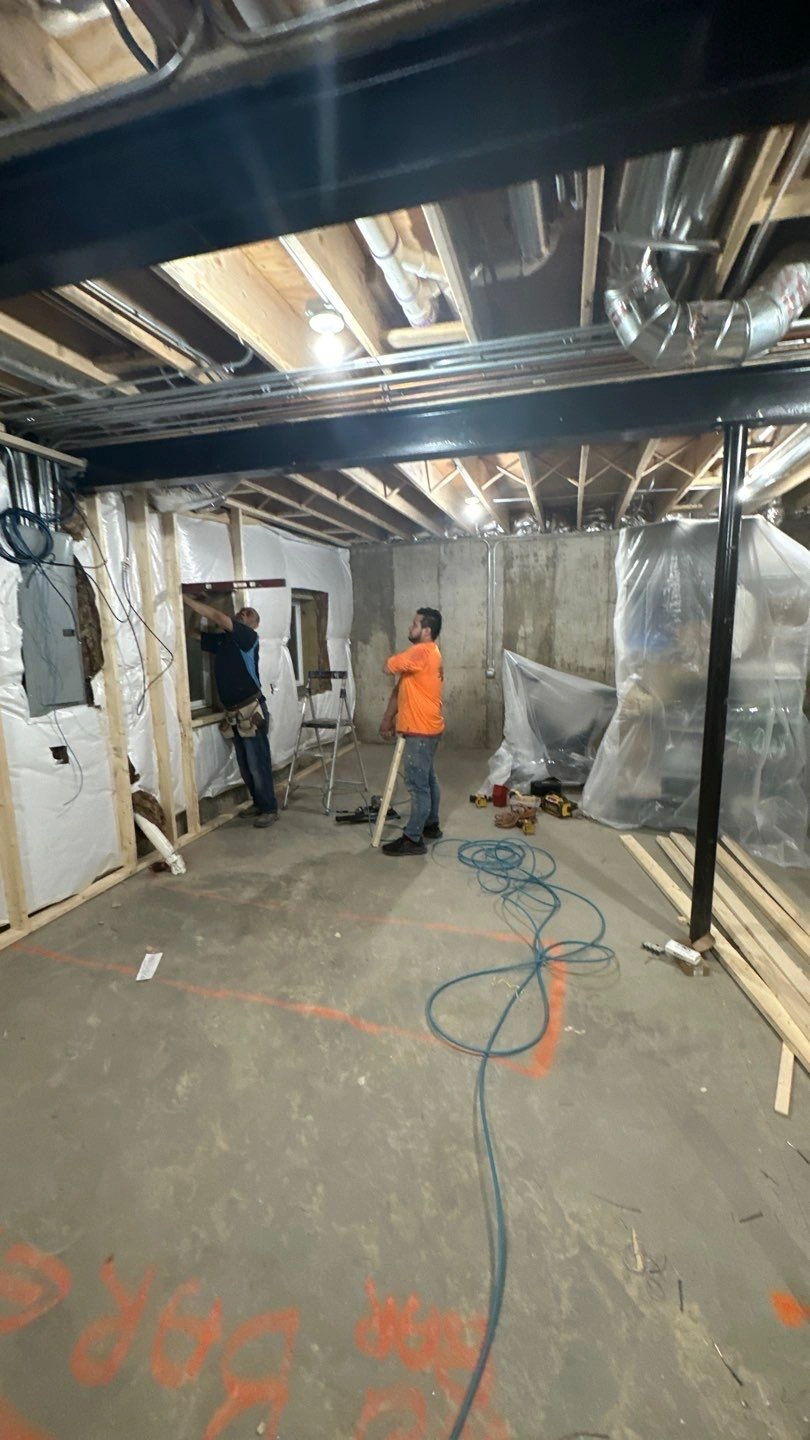 Workers engaged in basement renovation