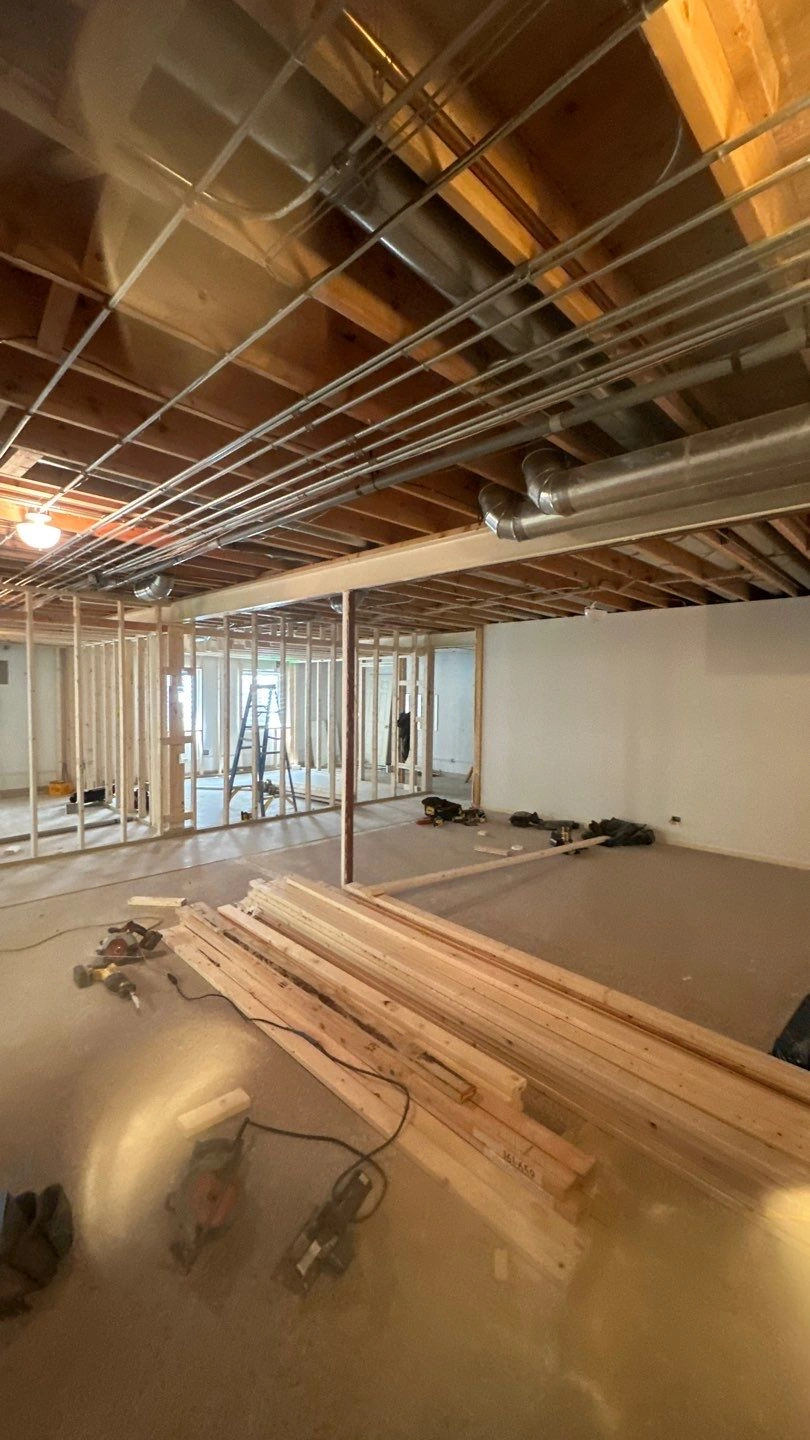 Interior construction site showing framed walls and tools
