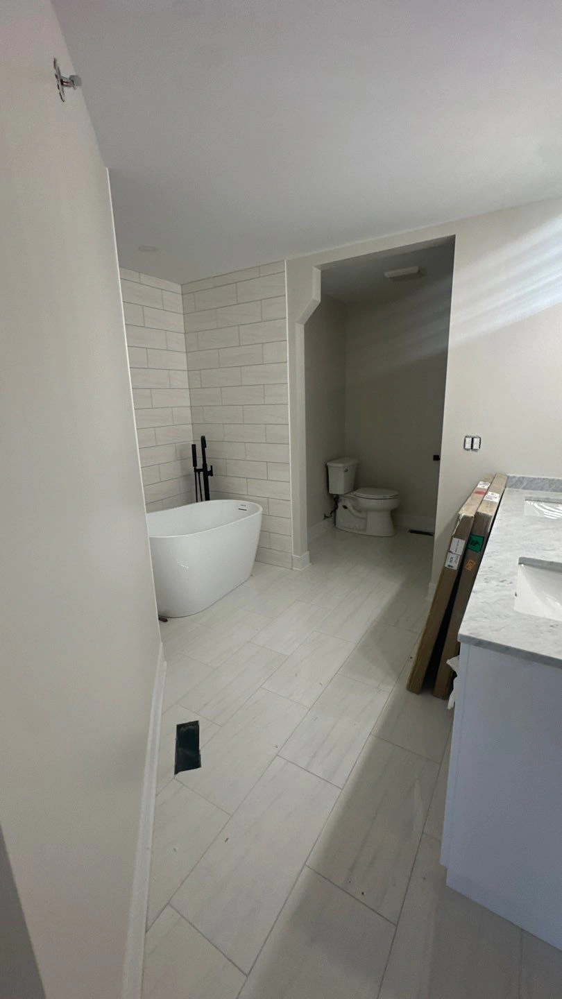 Modern bathroom with freestanding tub and toilet