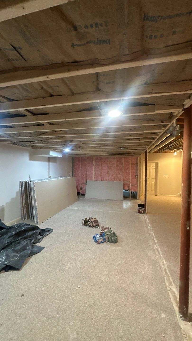 Renovated basement with construction materials and lighting
